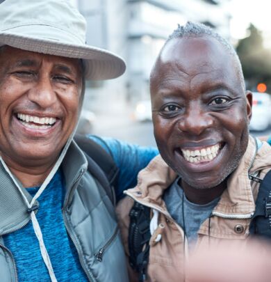 Elderly travel, portrait men and selfie of senior friends in a city with happiness and freedom on v