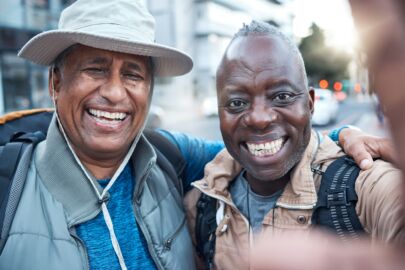 Elderly travel, portrait men and selfie of senior friends in a city with happiness and freedom on v